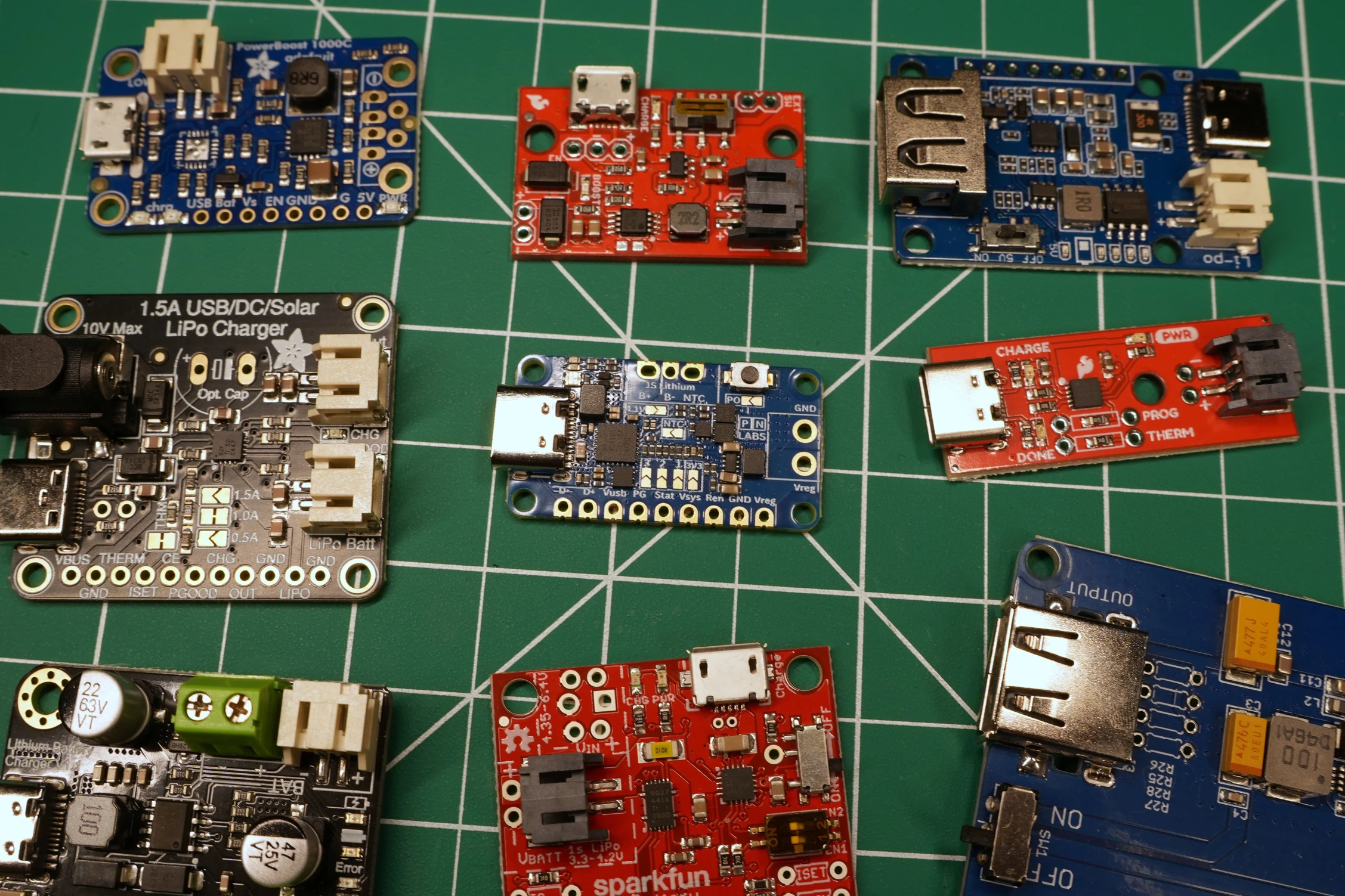 Battery Pal beside a TP4056 module, Adafruit PowerBoost 1000C, and SparkFun Battery Babysitter, showing relative size